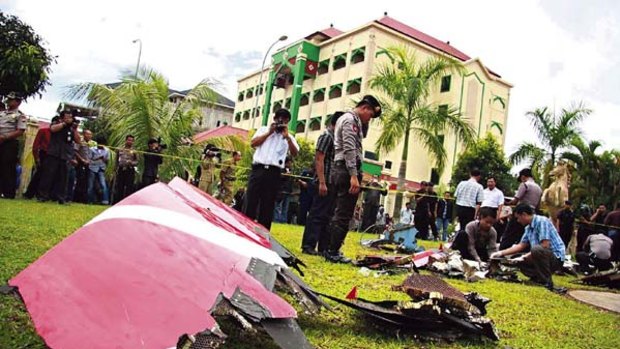 Indonesian police examine fallen debris on Batam island.