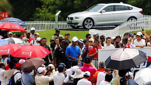 Tiger Woods is followed by a huge crowd on the 16th hole.