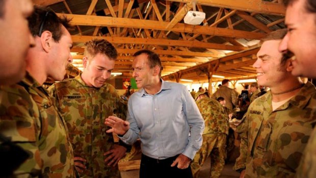 Troops button-hole Tony Abbott for his views on the beret ban.