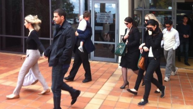 Family members of three men charged over a daylight robbery in Cabramatta leave Campbelltown Local Court on Thursday.