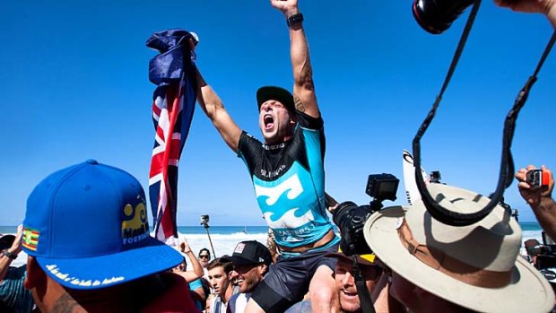 Three-peat: Australia's Mick Fanning is chaired up he beach after winning the ASP World Title for the third time.