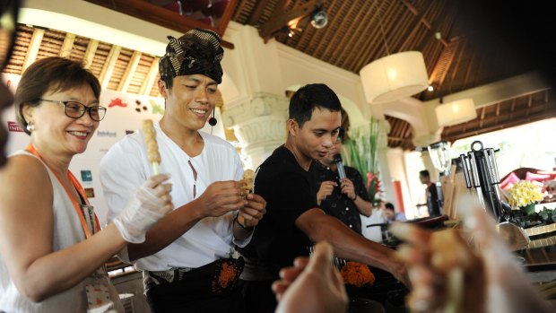 Ubud chef Made Lugra makes sate lilit, a popular local seafood sate, with his audience.