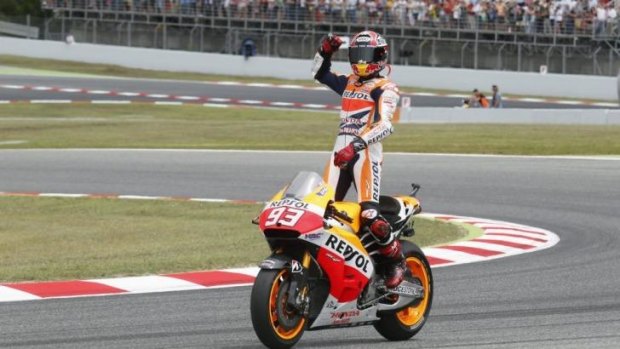 Marc Marquez does a celebratory lap after his win.