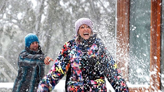 Ryan Whatford and Lana Scodille make the most of the snow at Falls Creek yesterday.