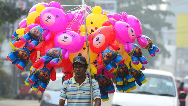 A Sri Lankan street vendor sells inflatable toys on a road in Colombo this: the nation is set to go the polls on January 8.