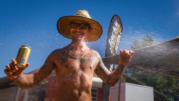 Chris Barac from Bonython is hosed down during the heat of the day at Summernats.