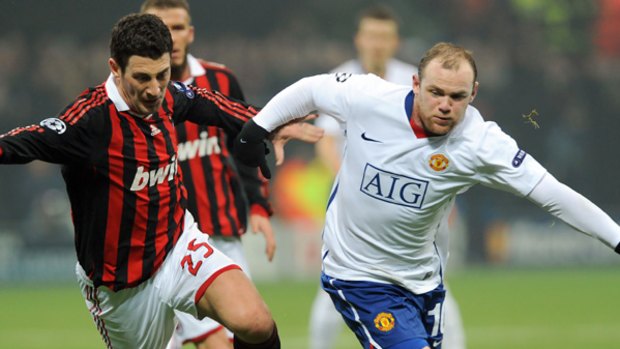 "Exploited"  ... Wayne Rooney, right, in action for Manchester United against AC Milan this morning.