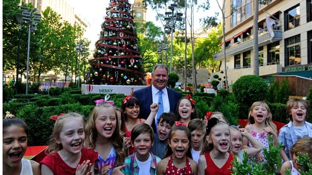 Lord Mayor Robert Doyle with kids from the May Downs dancing school in front of the Christmas tree in the city square.