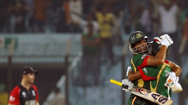 Mohammad Mahmudullah, left, celebrates with teammate Sahfiul Islam after their unbeaten 58-run partnership secured victory for Bangladesh.
