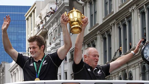 Vindicated ... New Zealand All Blacks captain Richie McCaw, left, holds up the Webb Ellis Cup with coach Graham Henry after the All Blacks victorious 2011 World Cup campaign.