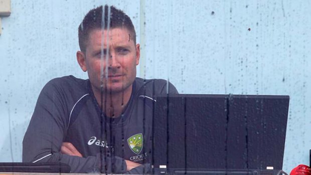 Praying for more rain? .... Michael Clarke looks on rain completely washed out day two at the Gabba.