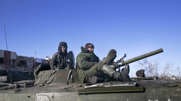 Fighters with separatist self-proclaimed Donetsk People's Republic army sit on top of an armoured personnel carrier as they head back to the front line from the village of Nikishine, south-east of Debaltseve.