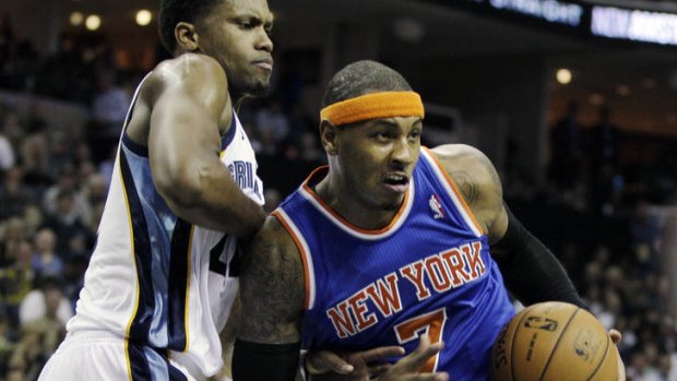 New York Knicks forward Carmelo Anthony pushes past Grizzlies opponent Rudy Gay in Memphis.