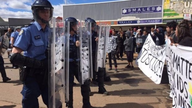 Riot police come face to face with protesters in Kalgoorlie.