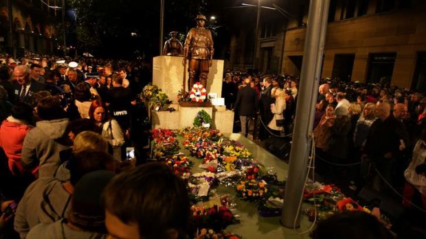 Large crowds pay their respects at the centotaph moments after the 99th ANZAC dawn service at the Martin Place war memorial, Sydney.