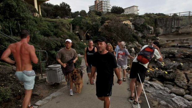 Path of conflict ... joggers, sculpture fans and dog walkers on the coastal walk between Bondi and Tamarama during Sculpture by the Sea.