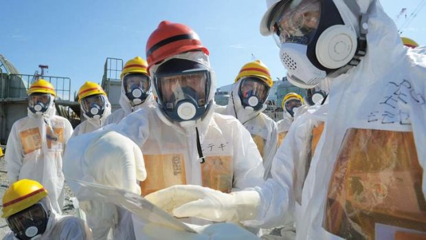 Intervention: Japan's Economy, Trade and Industry Minister, Toshimitsu Motegi (centre), inspects the Fukushima plant.