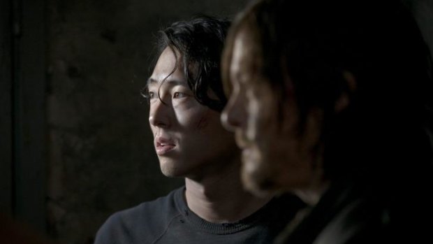Steven Yeun, left, and Norman Reedus in <i>The Walking Dead</i>.