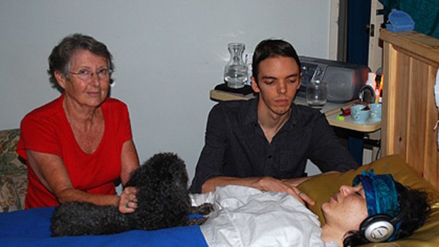 Theda's partner Blake Graham, mother Carol Adams at her bedside at home in Willetton.