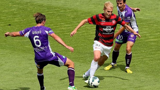 Side-splitting attack &#8230; Wanderer Aaron Mooy slaloms through the Glory defence of Nick Ward and Liam Miller at nib Stadium on Sunday. Mooy set up the winning goal in the first half.