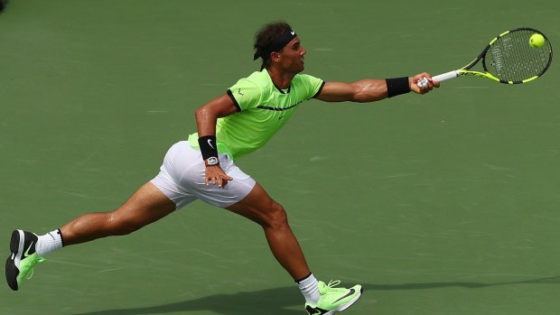 Rafael Nadal of Spain returns a shot against Roger Federer.