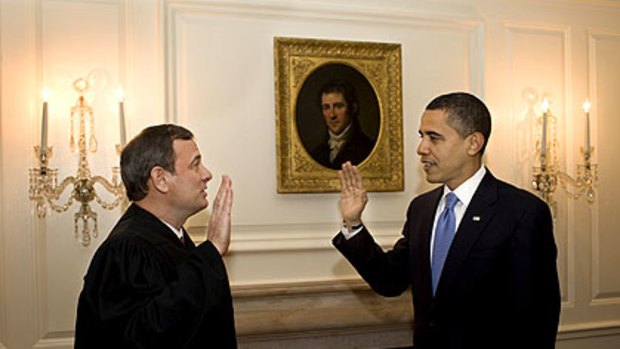 US President Barack Obama retakes the oath of office from Chief Justice John Roberts. Mr Obama took the oath again because Justice Roberts had led him to stumble over the words during the inauguration.