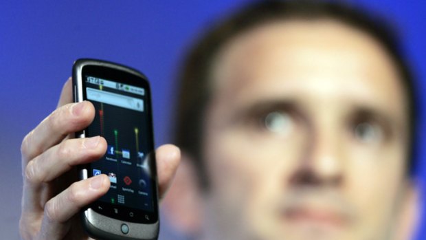 Mario Queiroz, Vice President of Product Management for Google, holds up the Nexus One phone during a news conference at Google headquarters in Mountain View, California.