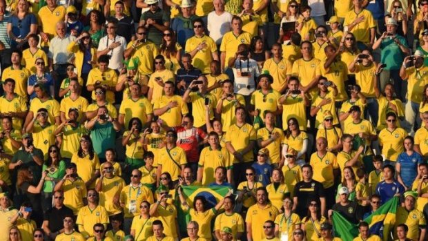 Expect to win ... Brazilian fans sing their national anthem ahead of the Group A football match between Brazil and Croatia