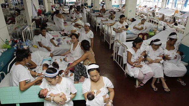 Losing battle ... mothers with their babies in a ward of the Jose Fabella maternity hospital in Manila. There are 300 mothers in the ward. Between 75 and 100 babies are born there every day.