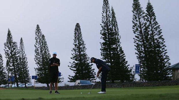 Matt Kuchar putts on the practice green during a weather delay in the Tournament of Champions at Kapalua, Hawaii.