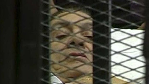 Looking frail ... Hosni Mubarak, charged with ordering the murders of 850 demonstrators, was wheeled in on a stretcher to face court in Cairo.