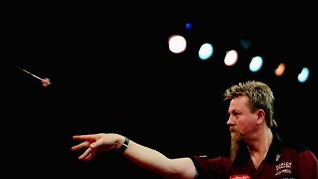 Target practice ... Simon Whitlock fires in a dart on his way to a comfortable win against Denis Ovens.