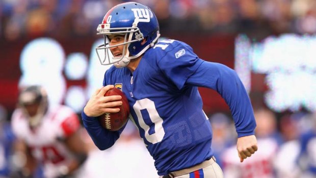 Hard yards &#8230; Eli Manning runs the ball for the New York Giants.