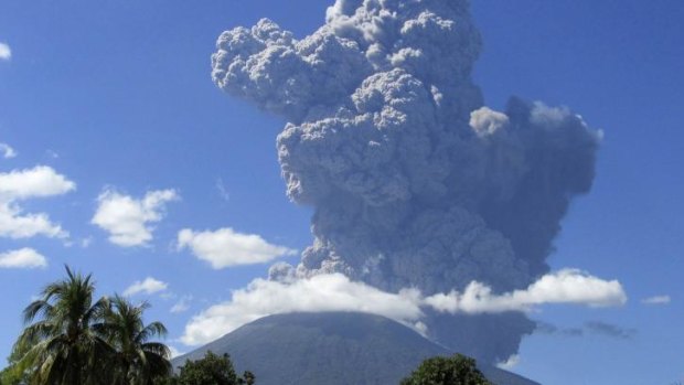 The Chaparrastique volcano in El Salvador volcano spews ash into the air.