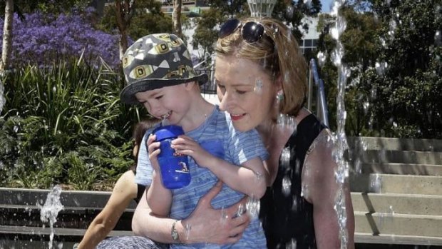 Back in ABC's hot seat: Leigh Sales and son Daniel at Darling Harbour's Water Park.