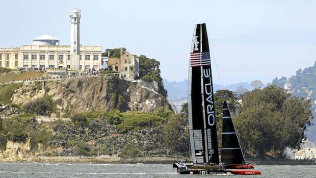 Oracle Team USA passes Alcatraz Island during race 14.