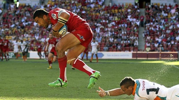 Digby Ioane flies high for the Reds at Suncorp.