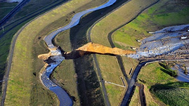 Floodwaters surge into the open-cut mine, damaging a conveyor system taking coal to the Yallourn power plant.
