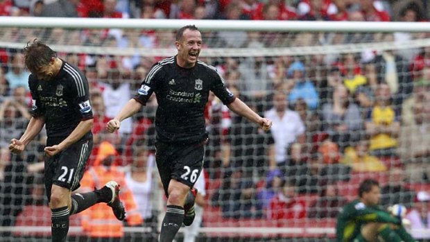 Lucky break: Liverpool's Lucas Leiva and Charlie Adam celebrate after Arsenal scores an own goal.