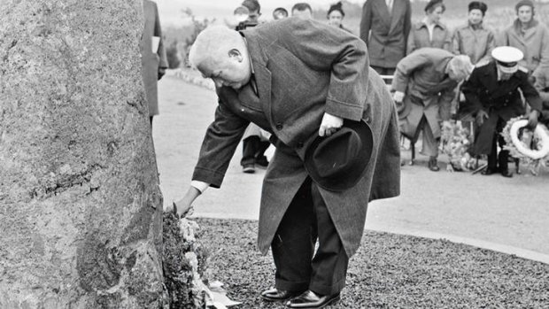 Lest we forget … Prime Minister Robert Menzies places a wreath on the memorial cairn to the air disaster at Fairbairn, Canberra on August 12, 1960.