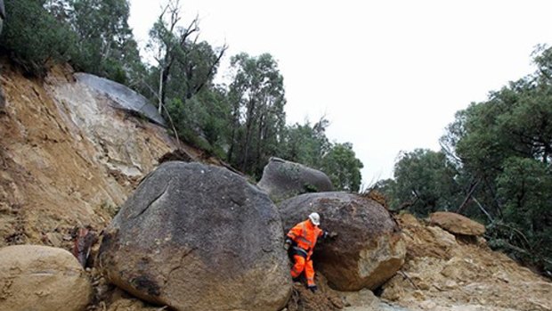 Stranded ... Large boulders block traffic on the road to Mount Buffalo.