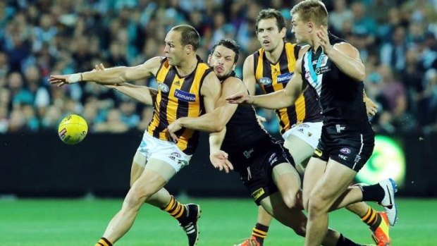 Got you: Port’s Travis Boak tackles Hawk Brad Sewell at Adelaide Oval. 