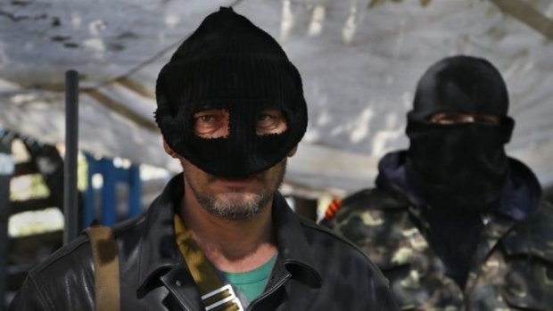 Masked pro Russian militants stand guard at the barricades in Slaviansk.