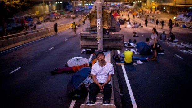 Democracy protestors sleep on the streets ahead of an ultimatum from Hong Kong authorities to open roads.