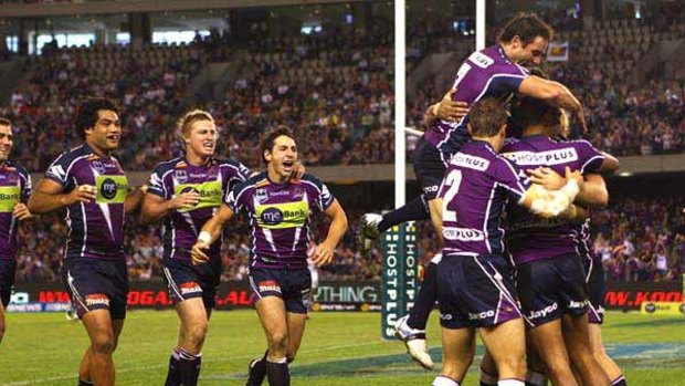 Spot the try-scorer . . . somewhere in the middle of that Melbourne Storm huddle is Dane Nielsen, first to cross the try line in the home side's 17-4 victory over St George Illawarra at Etihad Stadium yesterday.