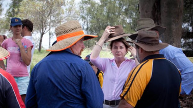 In touch ... the Queensland Premier, Anna Bligh, meets volunteers in the heat and humidity of flood-affected Karalee, a suburb of Ipswich.