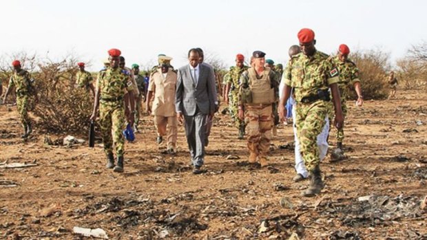Burkina Faso's President Blaise Compaore, centre, visits the crash site. 