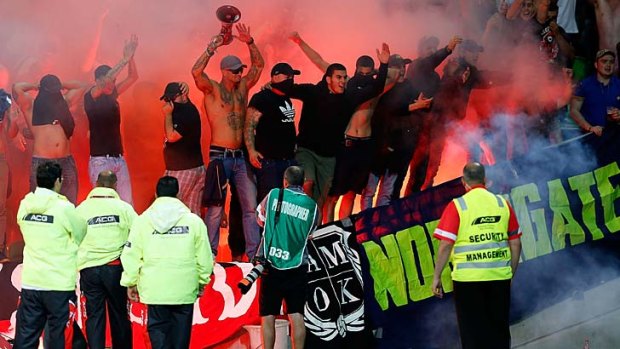 Wanderers fans let off flares during the match against Melbourne Victory in Melbourne.