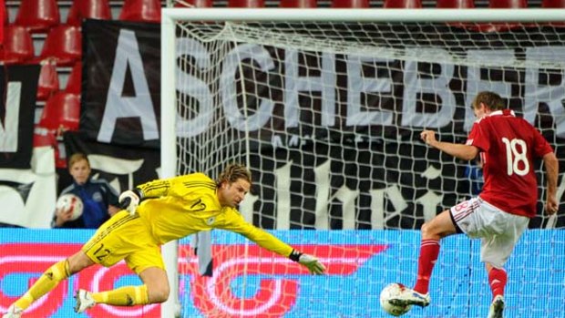 Germany's goalkeeper Tim Wiese fails to save a goal by Denmark's Mads Junker.