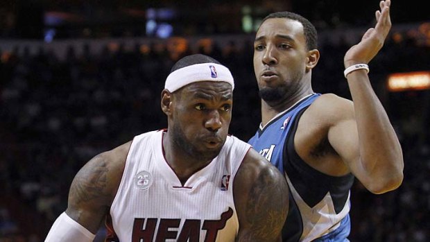 Miami Heat's LeBron James drives against Minnesota Timberwolves' Kevin Love.